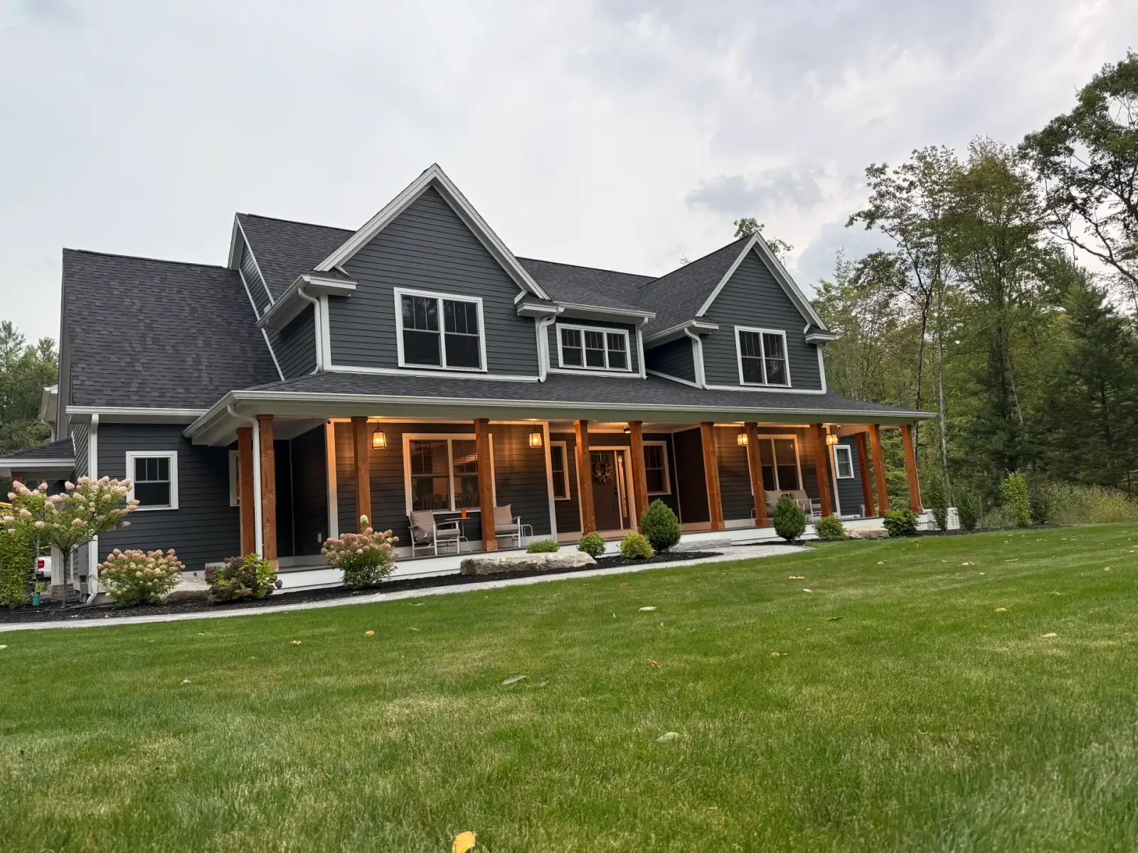 Dark-sided custom home with a covered timber porch
